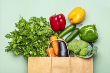 Paper grocery bag full of produce.